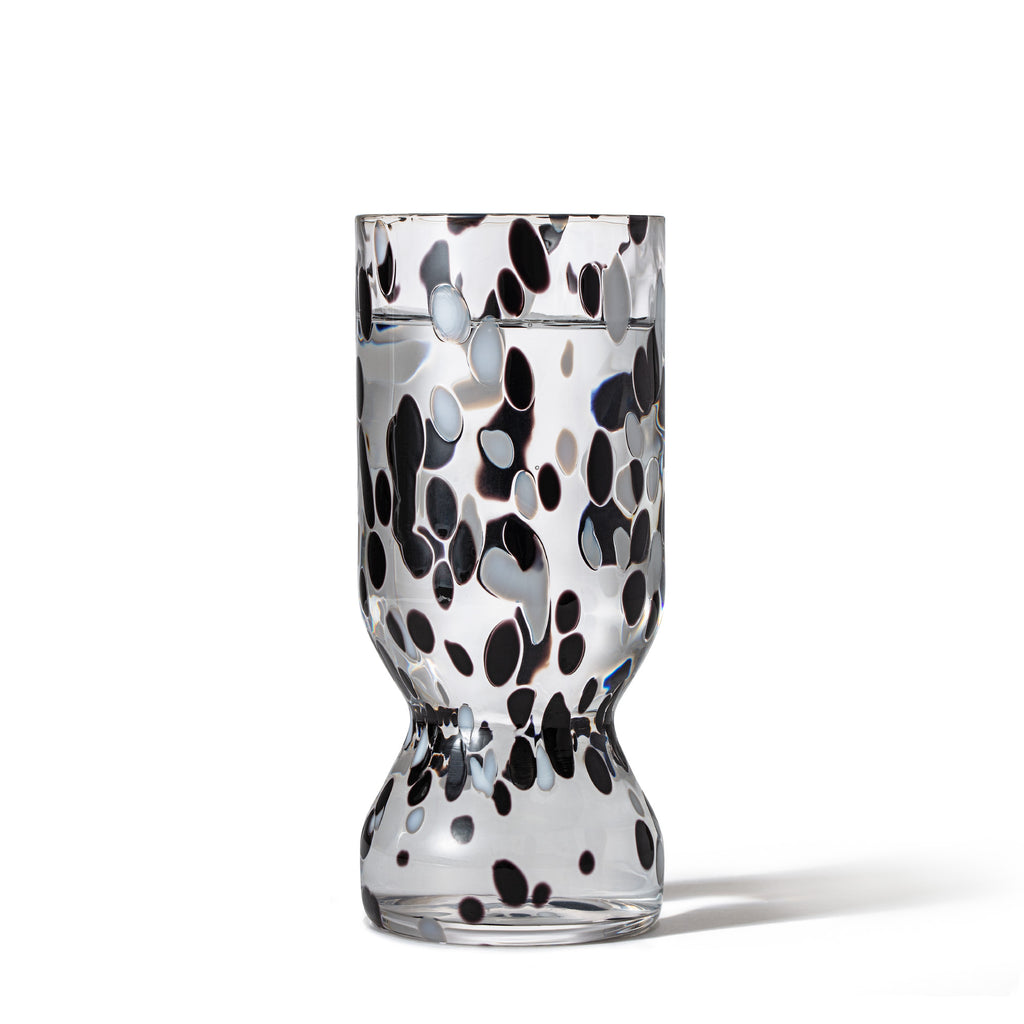 Hand-blown COSMIC crystal flute filled with water showing unique cosmic pattern.