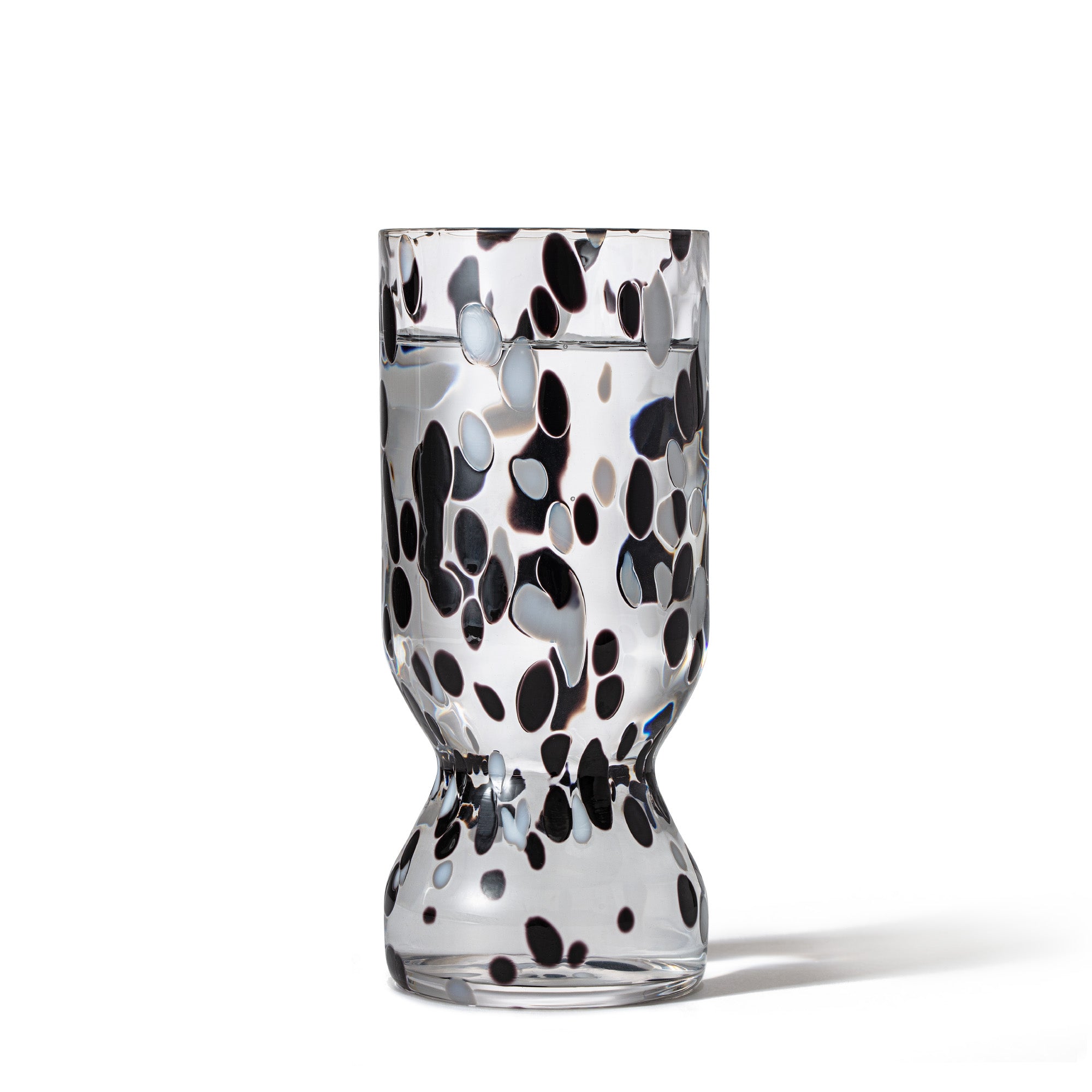 Hand-blown COSMIC crystal flute filled with water showing unique cosmic pattern.